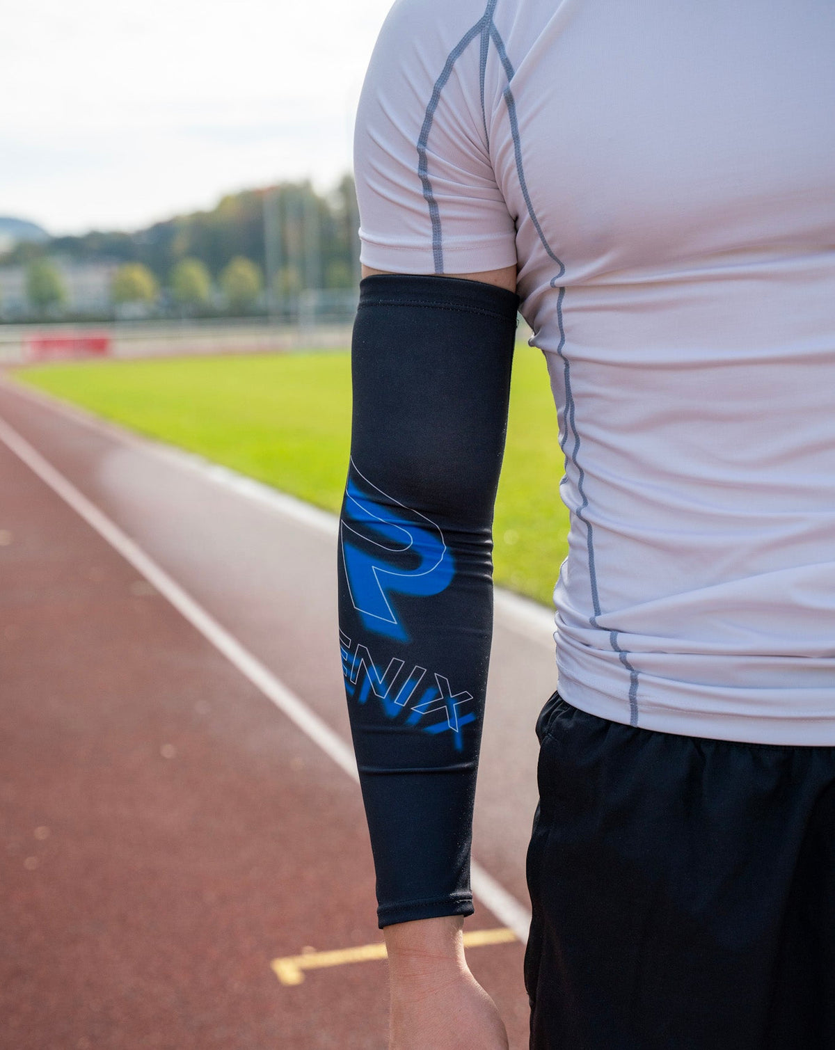Regenix Performance arm sleeves in black, shown on a person's arms, designed for athletic support and compression during sports.